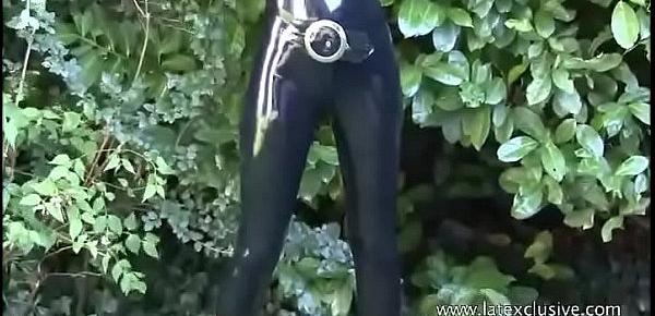  Latex lover Olivias outdoor fetish wear and long rubber boots on brunette babe i